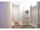Inviting entryway featuring neutral tones, decorative wreath, and staircase access enhancing the home's welcoming ambiance at 8317 Pine Branch Ln, Indianapolis, IN 46234