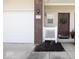 View of the front entrance featuring a maroon door with a decorative wreath and a white fence at 8317 Pine Branch Ln, Indianapolis, IN 46234