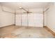 Spacious garage interior featuring an automatic door and concrete flooring at 8317 Pine Branch Ln, Indianapolis, IN 46234