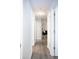 Hallway with white doors and wood-look floors at 8317 Pine Branch Ln, Indianapolis, IN 46234