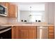 Updated kitchen featuring modern faucet, stainless steel dishwasher, and sleek countertops, perfect for culinary enthusiasts at 8317 Pine Branch Ln, Indianapolis, IN 46234