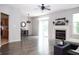 Spacious living room boasts a fireplace, modern light fixture, sliding glass door access, and wood flooring at 8317 Pine Branch Ln, Indianapolis, IN 46234