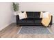 Living room featuring a black couch, accent pillows, and area rug at 8317 Pine Branch Ln, Indianapolis, IN 46234