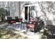 Outdoor patio with stylish seating, including chairs and a small sofa with red cushions, and a patterned rug at 8317 Pine Branch Ln, Indianapolis, IN 46234
