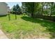 Fenced backyard featuring a lush lawn, mature trees, and a secure perimeter at 8354 Fieldfare Way, Indianapolis, IN 46237