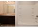 Bright bathroom with a shower-tub combo, toilet, and a vanity with a sink and mirror at 8354 Fieldfare Way, Indianapolis, IN 46237