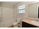 Bright bathroom with a shower-tub combo, toilet, and a vanity with a sink and mirror at 8354 Fieldfare Way, Indianapolis, IN 46237