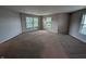 Bright bedroom with plush carpet, neutral walls, and multiple windows with blinds for ample natural light at 8354 Fieldfare Way, Indianapolis, IN 46237