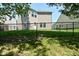 Backyard view of a home featuring a fenced yard, large windows, and neutral siding at 8354 Fieldfare Way, Indianapolis, IN 46237
