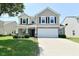 Traditional two-story home with a large two car garage and beautiful front lawn at 8354 Fieldfare Way, Indianapolis, IN 46237