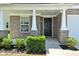 Charming front entryway showing detailed pillars, a black door, and manicured shrubbery at 8354 Fieldfare Way, Indianapolis, IN 46237