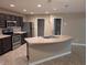 Modern kitchen with stainless steel appliances, dark wood cabinets, and a functional center island at 8354 Fieldfare Way, Indianapolis, IN 46237