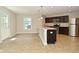 A kitchen features stainless appliances, wood cabinets, island with sink and pendant lights at 8354 Fieldfare Way, Indianapolis, IN 46237