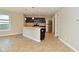 Open kitchen featuring stainless steel appliances, island with sink, and tile flooring at 8354 Fieldfare Way, Indianapolis, IN 46237
