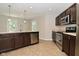 A kitchen features stainless appliances, wood cabinets, and an island with a sink at 8354 Fieldfare Way, Indianapolis, IN 46237