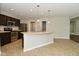 A kitchen features stainless appliances, wood cabinets, island with sink and pendant lights at 8354 Fieldfare Way, Indianapolis, IN 46237