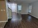 Inviting living room featuring sleek, dark wood floors, neutral walls, and a bright, open entryway at 8354 Fieldfare Way, Indianapolis, IN 46237