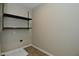 A utility room features shelving, washer hookups, and neutral paint at 8354 Fieldfare Way, Indianapolis, IN 46237