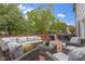 Spacious wooden deck with a gray wicker seating area and string lights overhead at 8430 Harrison Pkwy, Fishers, IN 46038