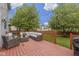Backyard featuring a red wooden deck furnished with patio furniture and string lights at 8430 Harrison Pkwy, Fishers, IN 46038