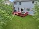 Backyard featuring a spacious deck with outdoor furniture, perfect for relaxation and entertaining, with a well-kept lawn at 8430 Harrison Pkwy, Fishers, IN 46038