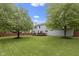 Spacious backyard featuring a well-maintained lawn, mature trees, and a wooden deck perfect for entertaining at 8430 Harrison Pkwy, Fishers, IN 46038