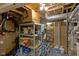Unfinished basement with exposed ceiling and a shelving unit filled with items at 8430 Harrison Pkwy, Fishers, IN 46038