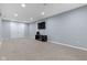 Spacious finished basement with a TV, fan, and storage. Perfect for entertaining or relaxing at 8430 Harrison Pkwy, Fishers, IN 46038
