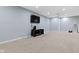 Carpeted finished basement featuring a ceiling fan and entertainment center at 8430 Harrison Pkwy, Fishers, IN 46038