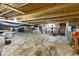 Unfinished basement with plastic sheeting on the floor and exposed wooden ceiling at 8430 Harrison Pkwy, Fishers, IN 46038