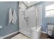Modern bathroom featuring glass-enclosed shower, white tiles, and blue wall paint at 8430 Harrison Pkwy, Fishers, IN 46038
