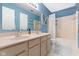 Bathroom with double sinks, shower-tub combo, and light blue walls at 8430 Harrison Pkwy, Fishers, IN 46038