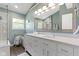 Bright bathroom featuring double vanity, framed mirror, walk-in shower, and coordinated fixtures at 8430 Harrison Pkwy, Fishers, IN 46038
