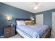 Cozy bedroom with blue walls, wooden furniture, and a comfortable bed with decorative quilt and pillows at 8430 Harrison Pkwy, Fishers, IN 46038