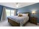 Comfortable bedroom featuring a ceiling fan, plush bedding, and soft natural light from the window at 8430 Harrison Pkwy, Fishers, IN 46038