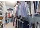 Walk-in closet featuring rows of hanging clothes and shoe storage shelves at 8430 Harrison Pkwy, Fishers, IN 46038