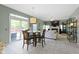 Open concept dining area with sliding doors to a backyard patio and a view into the living room at 8430 Harrison Pkwy, Fishers, IN 46038