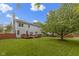 Back exterior of a gray two-story home with a wooden deck and spacious yard at 8430 Harrison Pkwy, Fishers, IN 46038