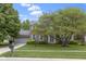 Charming two-story brick home with a well-manicured lawn and mature landscaping in a suburban neighborhood at 8430 Harrison Pkwy, Fishers, IN 46038