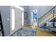 Bright foyer with hardwood floors, staircase, and a view into adjacent rooms creates a welcoming entrance at 8430 Harrison Pkwy, Fishers, IN 46038