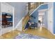 Spacious foyer featuring hardwood floors, a staircase, and stylish decor for an inviting entrance at 8430 Harrison Pkwy, Fishers, IN 46038