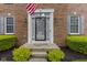 Inviting front entrance with a decorative door, sidelights, and manicured landscaping, enhancing curb appeal at 8430 Harrison Pkwy, Fishers, IN 46038