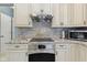 Close-up of kitchen details including granite countertops, stainless steel appliances, and decorative backsplash at 8430 Harrison Pkwy, Fishers, IN 46038