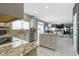 Bright kitchen features granite countertops and a view to the dining and living area at 8430 Harrison Pkwy, Fishers, IN 46038