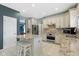 Well-appointed kitchen features an island with bar stools, stainless steel appliances, and custom cabinetry at 8430 Harrison Pkwy, Fishers, IN 46038