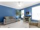 Bright living room with neutral carpet, blue walls, white trim, console table, and loveseat at 8430 Harrison Pkwy, Fishers, IN 46038