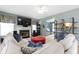 Comfortable living room with fireplace, shelving, and large TV at 8430 Harrison Pkwy, Fishers, IN 46038