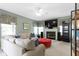 Spacious living room with a fireplace, large windows, and comfortable seating at 8430 Harrison Pkwy, Fishers, IN 46038