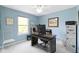 Home office with large desk, comfortable chair, and ample natural light at 8430 Harrison Pkwy, Fishers, IN 46038