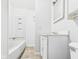 Clean bathroom featuring a tub-shower combo, vanity with mirror and light ceramic tile flooring at 903 W 22Nd St, Anderson, IN 46016